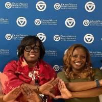 Black Alumni Network members pose for a photo in front of a GVSU backdrop.